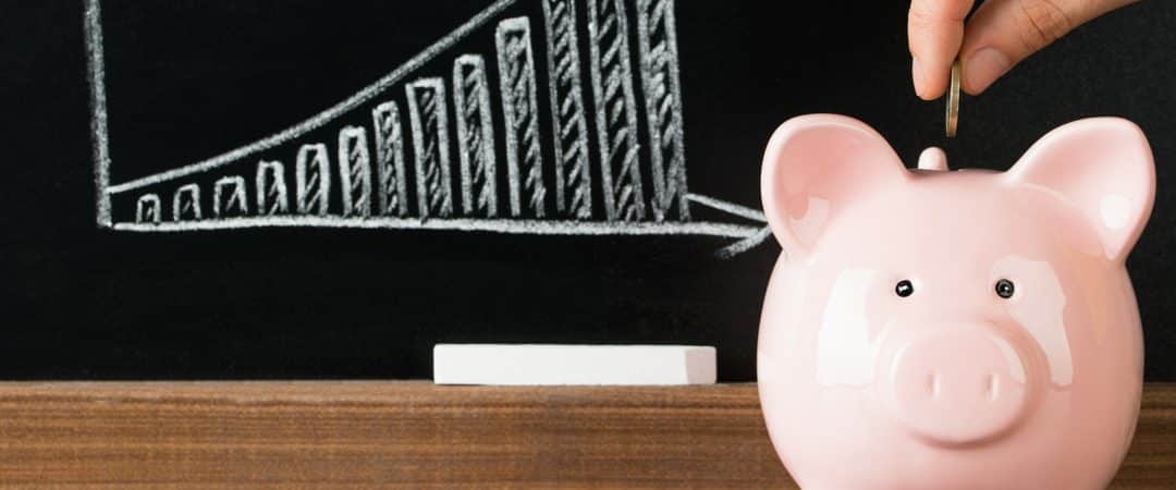 piggy bank in front of a chart showing how to save so you won't need a cash loan