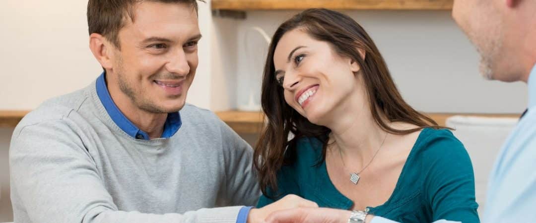 man and woman shaking hands with lender after obtaining title loan